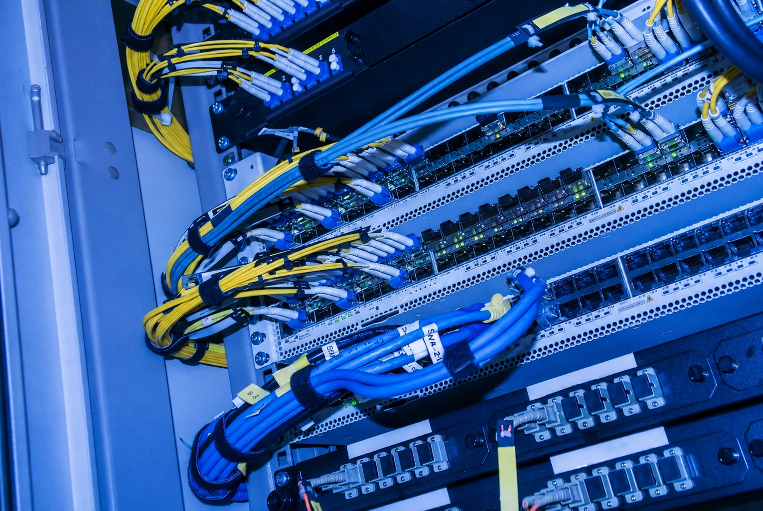 Fibre and copper patch cabling into a rack of network switches